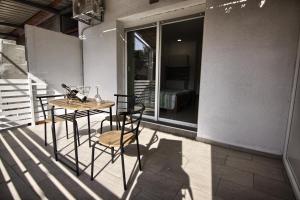 a table and chairs on a patio with a window at Rooms DRAGICA in Pakoštane