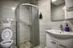 a bathroom with a toilet and a sink at Rooms DRAGICA in Pakoštane