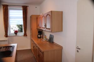 a kitchen with a wooden counter and a window at Ferienwohnung am Mühlbach in Klingenthal