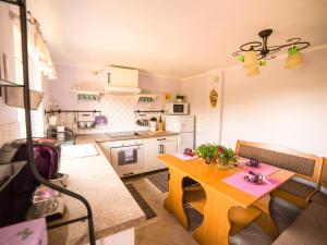 a kitchen with a table and a dining room at Zagroda u Macieja in Ustka