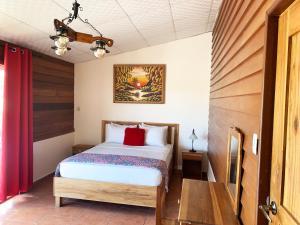 a bedroom with a bed and a table at Hotel Calle 6 in Bocas Town