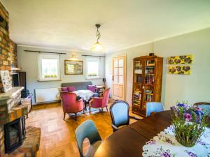 a living room with a table and chairs at Zagroda u Macieja in Ustka