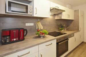 a kitchen with a microwave and a stove top oven at Der Landhof Schwalbennest LH-204 in Stolpe auf Usedom