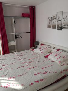 a bed with a white comforter and pillows on it at La Ruche Cantalienne in Saint-Étienne-de-Chomeil