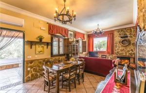 a dining room and living room with a table and chairs at Stunning Home In Crdoba With Kitchen in Carcabuey