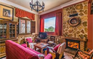 a living room with a fireplace and a stone wall at Stunning Home In Crdoba With Kitchen in Carcabuey