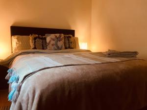 a bedroom with a large bed with two pillows at Letterkenny Town Centre Apartment in Letterkenny