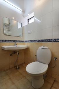 ein Bad mit einem WC und einem Waschbecken in der Unterkunft Hotel Himalayan Club in Masuri
