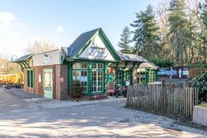 a small building with green trim on a street at Belle Dune in Fort-Mahon-Plage