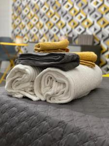a pile of towels sitting on top of a bed at VANNUCCI 71 APT in Perugia
