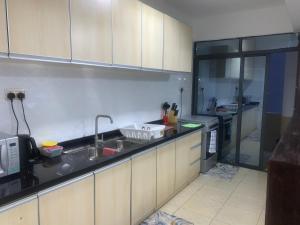 a kitchen with a sink and a counter top at Mideya Gardens in Nairobi