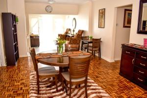 a kitchen and dining room with a table and chairs at Villa Palesa Guesthouse in Grahamstown