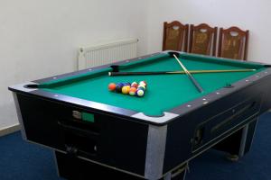 a pool table with balls on it in a room at Penzion Roháčan in Zuberec