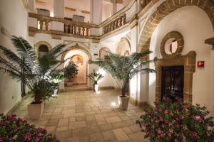 a hallway with potted plants in a building at Al Pescatore Hotel & Restaurant in Gallipoli