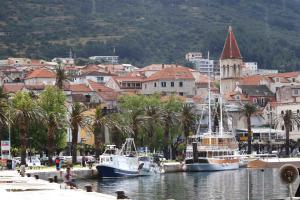 two boats are docked in the water near a city at Apartment Toni in Makarska