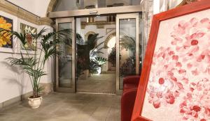 an entrance to a building with a painting of flowers at Al Pescatore Hotel & Restaurant in Gallipoli