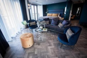 a living room with a couch and chairs and a bed at Waterfront Southport Hotel in Southport