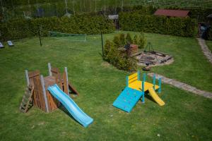 a backyard with a playground with slides and a play equipment at CISÓWKA in Sadowie