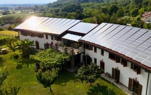 an aerial view of a house with solar panels on it at Le Ali del Falco in Cuceglio