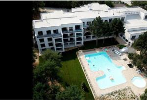 an aerial view of a building with a swimming pool at 365 apartmány LINEA in Piešťany