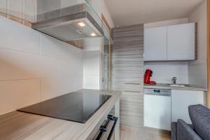 a small kitchen with a counter top and a sink at La Bouillandire in Les Gets