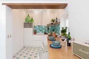 a kitchen with a wooden table with wine glasses at Petrea Lifestyle Suites in Positano