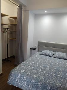 1 dormitorio con 1 cama con edredón azul en Ca la Nuri Pis 4 vistas al mar, en Llançà