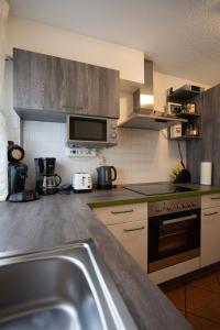 a kitchen with a sink and a stove top oven at Fewo Reutlingen Metzstraße OG 1 in Reutlingen