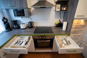 a small kitchen with a sink and a stove at Fewo Reutlingen Metzstraße OG 1 in Reutlingen