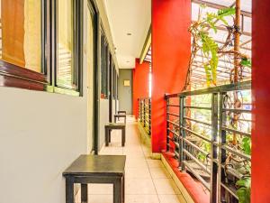 a hallway with a bench and red walls at Penginapan Marsya Prima Syariah in Jakarta