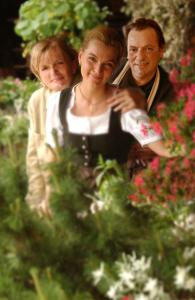 a man and a woman standing in a garden at Les Chalets-Hôtel de la Croix-Fry in Manigod