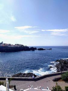 a view of the ocean with rocks in the water at Apartamento Neptuno playa 12 in Puerto de Santiago