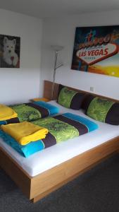 two twin beds in a bedroom with avertisement for at Ferienwohnung "beim Hirsch" Bregenzerwald in Langenegg