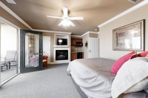 a bedroom with a bed and a ceiling fan at River Haus in Helen