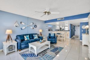 a living room with a blue couch and a table at Van Lee 1203 in Ormond Beach