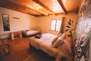 a bedroom with two beds and a window at Vientos San Pedro in San Pedro de Atacama