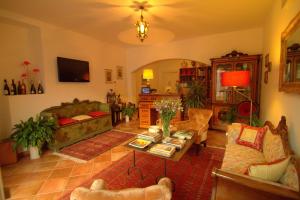 a living room with a couch and a table at Torre Archirafi Resort in Riposto