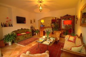 a living room with a couch and a table at Torre Archirafi Resort in Riposto