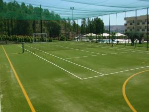 a tennis court with two tennis courts at Hotel San Giorgio in Crotone