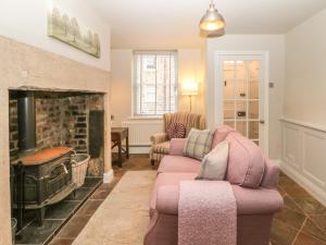 a living room with two chairs and a fireplace at Chapel Cottage in Corbridge