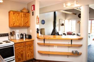 a kitchen with wooden shelves on the wall at Graceland Farm in Underberg