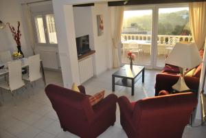 a living room with two couches and a dining room at Rosalalinda - cosy semi-detached home with sea views and large terrace in Moraira