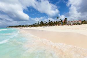 a beach with a group of people on it at Occidental Caribe - All Inclusive in Punta Cana
