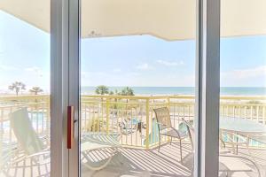 a view from the door of a patio with chairs and the ocean at Bay Watch 0232 in Myrtle Beach