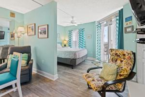 a living room with a bed and a chair at Bay Watch 0631 in Myrtle Beach