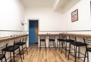 a bar in a room with black stools at MOVA 104 - Hotel Consulado Avenida Paulista in Sao Paulo