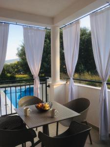 a table with a bowl of fruit on a balcony at Green Bay in Baošići