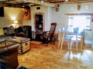 a living room with a table and chairs and a dining room at Castle Street Cottage in Ruthin