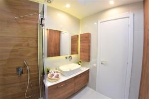 a bathroom with a sink and a mirror at Villa Sofias in Pefkochori