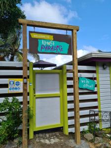 a garage with a sign in front of a house at Almost Paradise Cottage Retreats in Sauteurs